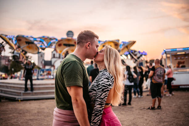 istock Loving couple in amusement park 1344290400