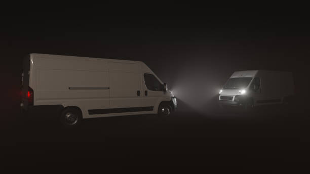 istock Two White Delivery Vans Facing Each Other in the Dark 1344290463