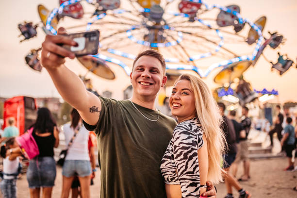 istock Couple making selfie in amusement park 1344290600