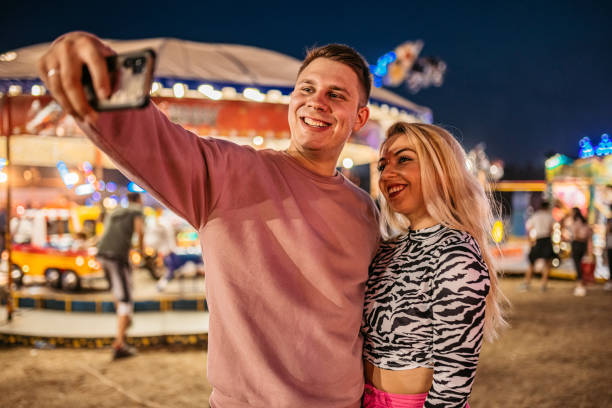 istock Couple making selfie in amusement park 1344290627