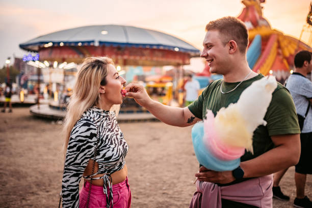 istock Boyfriend sharing cotton candy with girlfriend 1344290711