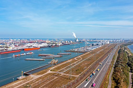 Container ship TSINGTAO EXPRESS of Hapag-Lloyd sailing in the port of Rotterdam seen from above. The Port of Rotterdam is the largest seaport in Europe, with several container terminals on the Maasvlakte.