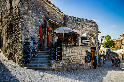 Tourists walking in the old streets of the medieval city of Les Baux de Provence, France