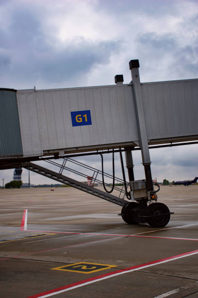 istock Jet bridge or passenger boarding bridge in airport 1344293119