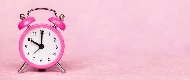 istock Save time, daylight savings, clock on a pink background, web banner 1344293364
