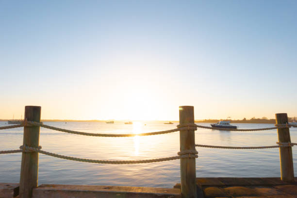 Sunrise warmth at waterfront for new day or travel background, Tauranga New Zealand.