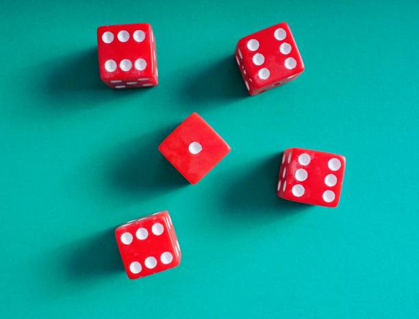 istock Red dice on green background for games of chance 1344296701