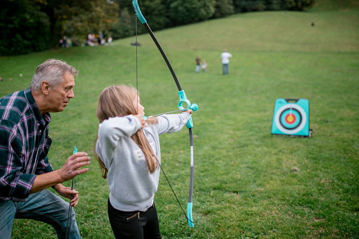 My father teaches me archery