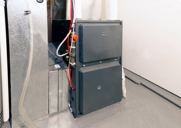 A home high energy efficient furnace in a basement A home high energy efficient furnace in a basement cleanroom photos stock pictures, royalty-free photos & images