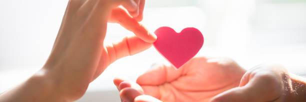 istock Woman Giving Heart On Man's Hand 1344305231