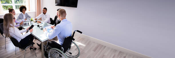 istock Disabled Manager Sitting With His Colleagues 1344305259