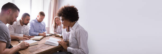 istock Group Of Young Multiethnic People Reading Bible 1344305272