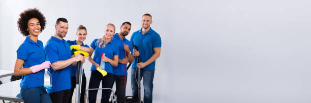 Portrait Of Happy Male And Female Janitors Portrait Of Happy Male And Female Janitors With Cleaning Equipment custodian stock pictures, royalty-free photos & images