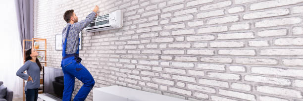 istock Woman Looking At Technician Repairing Air Conditioner 1344305314