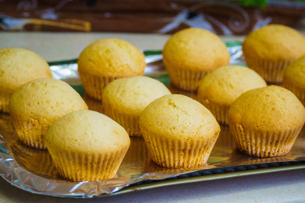 istock Cool freshly baked vanilla muffins on a metal sheet. 1344307707