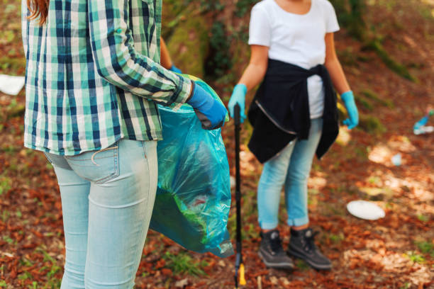 istock Cleanup volunteers collecting trash in the forest 1344309910