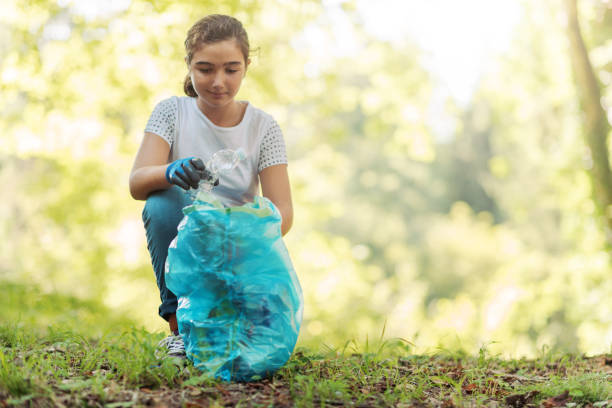 istock Young volunteer cleaning up a forest 1344310767