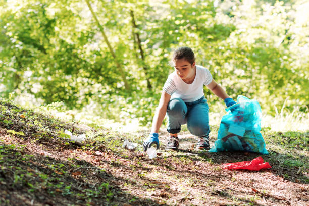 Young volunteer cleaning up a forest stock photo