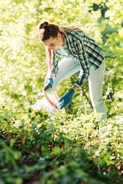 istock Young cleanup volunteer collecting trash in the forest 1344311034