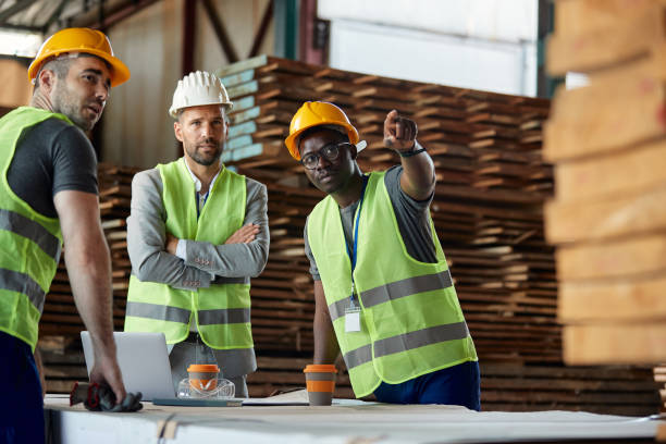 istock Male workers talking to their manager while having a meeting at lumber warehouse. 1344313043