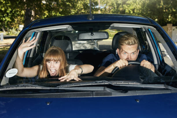 istock Young couple react to danger with shock and horror as they drive in a car 1344313673