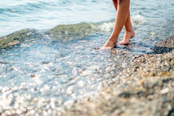 istock Young woman walks at beach during sunset 1344313741