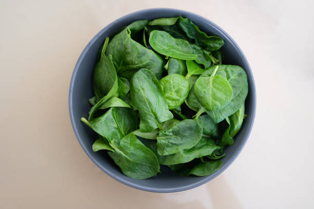istock Fresh spinach leaves in bowl on table. Top view. 1344313746