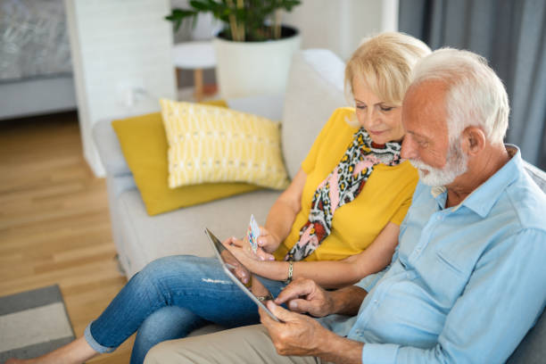 istock Happy senior couple using electronic banking at home. 1344317908