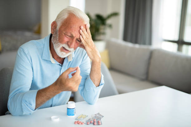 istock Unwell senior man taking pills. 1344317943