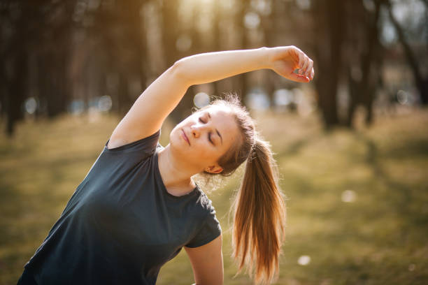 istock Woman athlete stretching in the forest 1344317990