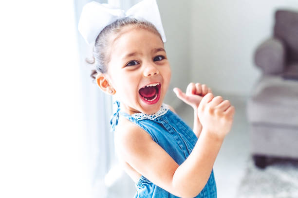 Wild child, excited and expressive little girl with big personality screams in happiness Screaming child mouth open human face shouting screaming stock pictures, royalty-free photos & images