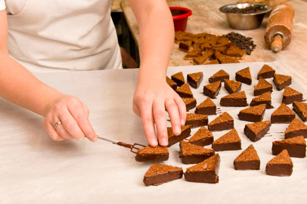 istock Confectioner preparing nut wedges with chocolate 1344323955
