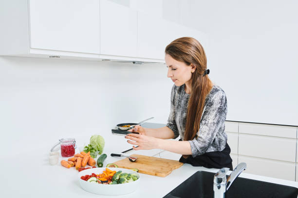 istock Beautiful woman working in kitchen 1344324643