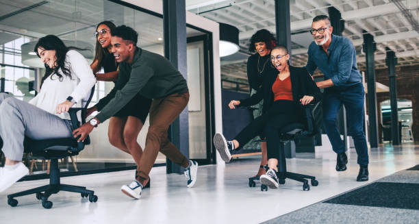 istock Cheerful coworkers enjoying playtime together at work 1344324807