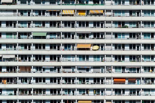 Residential building view in Berlin. Facade of a big apartment building with small balconies.
