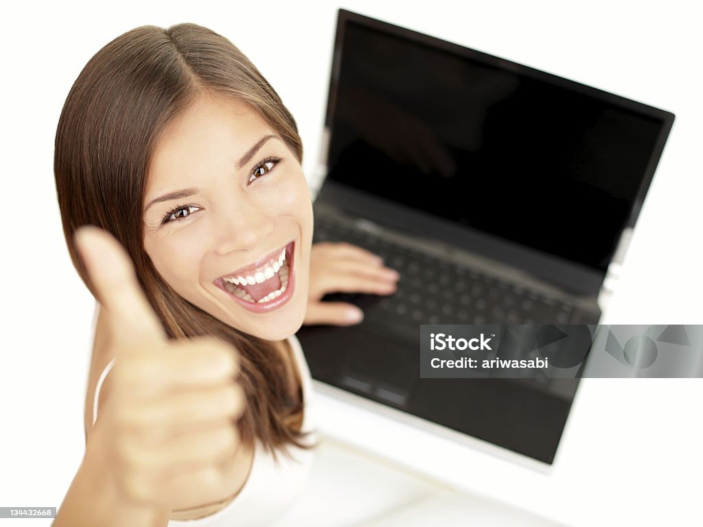 laptop woman happy Laptop woman happy giving thumbs up success sign sitting at computer PC with excited face expression. Beautiful smiling cheerful multiracial Asian Caucasian student girl on white background. See more: Thumbs Up Stock Photo