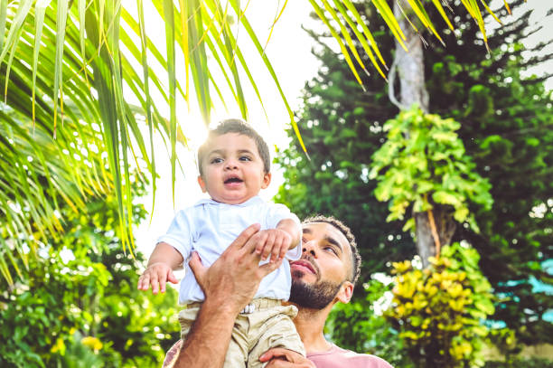 istock Father spending time together outdoors with his adorable expressive mixed race toddler son 1344328562
