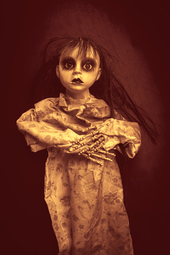 A creepy doll with boney hands.
