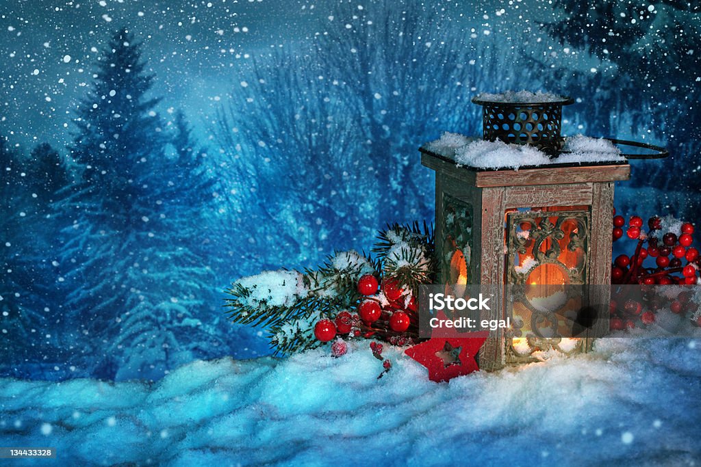 Burning lantern Burning lantern in the snow at night Christmas Stock Photo