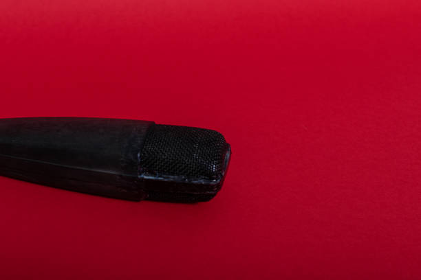 istock Top view black microphone on red background. Copy space. HD stock Photo. 1344336791