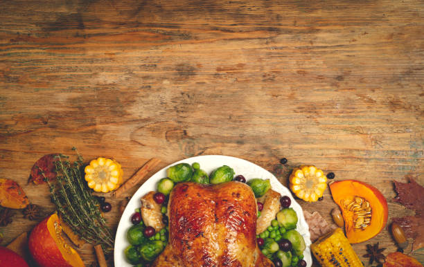 istock Thanksgiving turkey or chicken for a festive dinner. Food table background with autumn seasonal specialties for Thanksgiving Day. Fried chicken with pumpkin, vegetables and autumn decor on a wooden table background. 1344336821