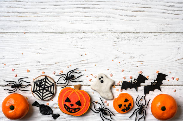 istock Halloween background with cookies, ghost and bats, top view 1344338892