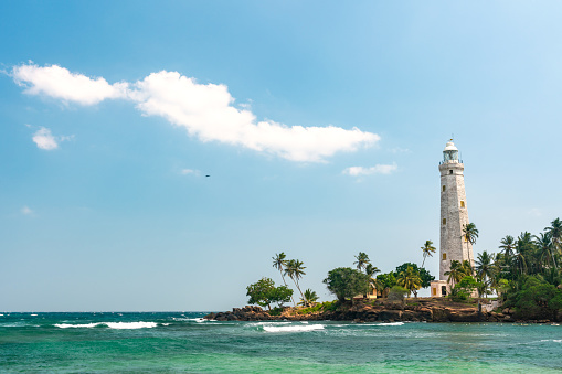 Beautiful beach and White lighthouse Dondra in Sri Lanka. High quality photo