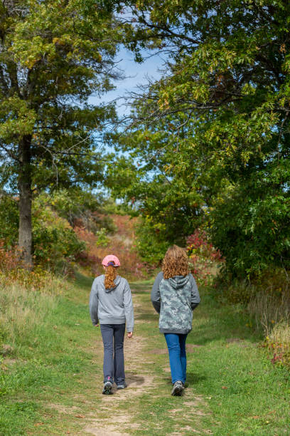 istock Two Girls Going For Walk in Woods in Autumn 1344344048