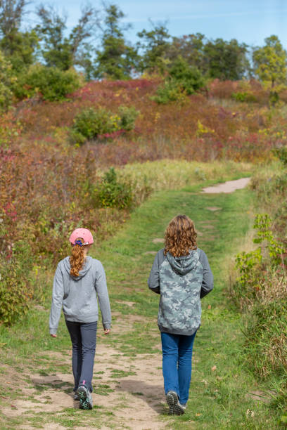 istock Two Girls Going For Walk in Autumn 1344346037