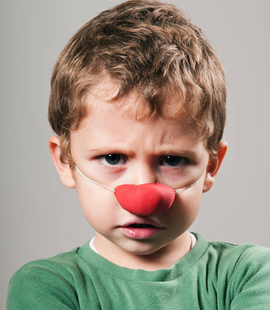 istock Angry little kid with clown nose 134435287