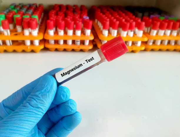 Test tube with blood sample for magnesium (Mg) test. Test tube with blood sample for magnesium (Mg) test. magnesium deficiency stock pictures, royalty-free photos & images