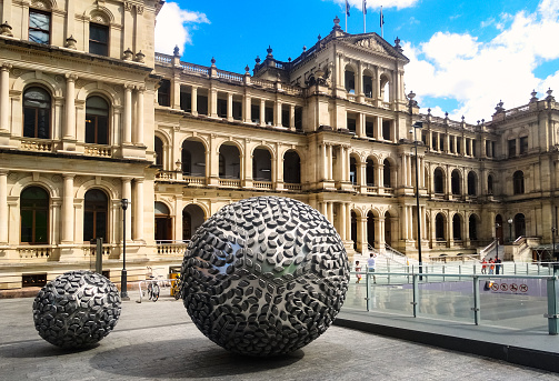 Facade of the Treasury Building with the Steam sculptures by sculptor Donna Marcus in downtown Brisbane, Queensland, Australia on a sunny day.