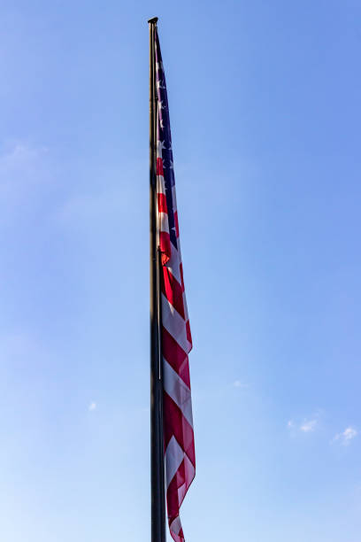 istock American flag in still air with blue sky 1344360363