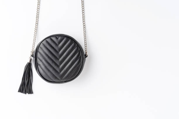 istock Black elegant shoulder bag isolated on white background with copyspace. Flat lay 1344371131